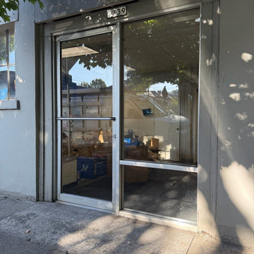 After — commercial entrance glass replaced and secured.