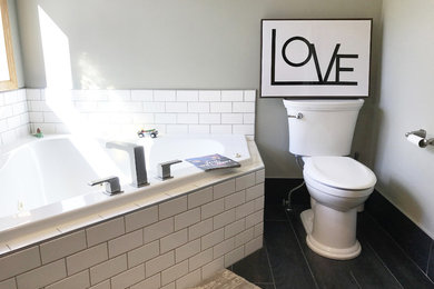 Example of a large trendy master white tile and ceramic tile ceramic tile and black floor bathroom design in Other with a hot tub, a two-piece toilet, gray walls, granite countertops, raised-panel cabinets, gray cabinets and an integrated sink
