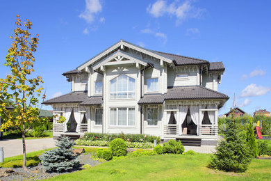 Inspiration for a large two-storey grey house exterior with wood siding and a tile roof.