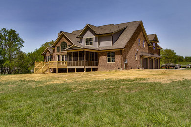 Inspiration for a large timeless brown two-story brick gable roof remodel in Nashville