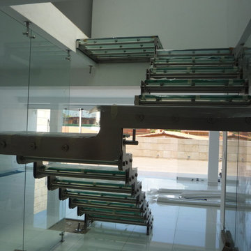 Staircase E design - Floating with glass and Stainless Steel.