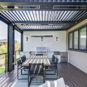 Adjustable StruXure Pergola Featuring Outdoor Kitchen With Screens & Heaters