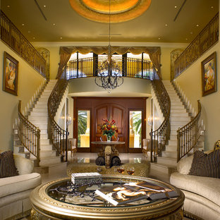 Inspiration for a large mediterranean curved metal railing staircase in Miami with marble treads and marble risers.