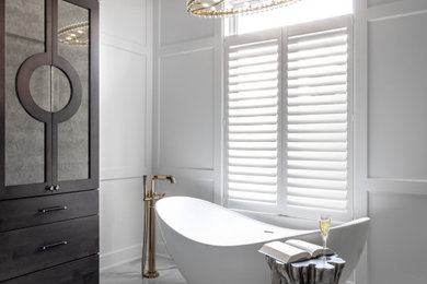 Large transitional master white tile and porcelain tile white floor, double-sink, wainscoting and porcelain tile freestanding bathtub photo in Detroit with furniture-like cabinets, dark wood cabinets, white walls, a drop-in sink, quartzite countertops, a hinged shower door, beige countertops and a built-in vanity
