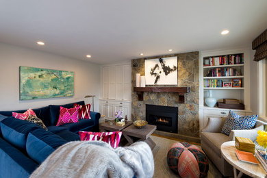 Transitional medium tone wood floor living room photo in Denver with white walls, a standard fireplace and a stone fireplace