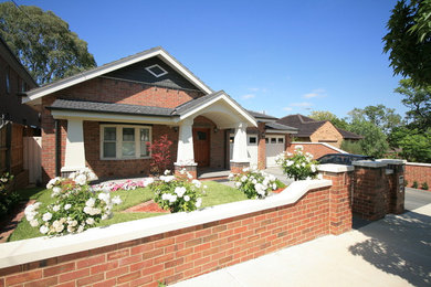Design ideas for an arts and crafts one-storey brick house exterior in Melbourne with a gable roof and a tile roof.
