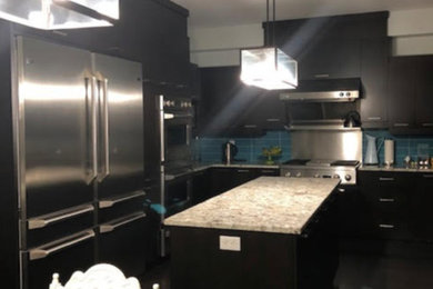 Huge minimalist u-shaped dark wood floor and brown floor open concept kitchen photo in Montreal with an undermount sink, flat-panel cabinets, dark wood cabinets, granite countertops, blue backsplash, ceramic backsplash, stainless steel appliances, an island and beige countertops