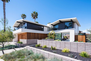 Inspiration for a mid-sized mid-century modern two-story exterior home remodel in Orange County