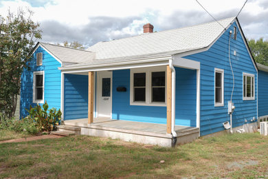 Inspiration for a mid-sized timeless blue one-story concrete fiberboard house exterior remodel in Other with a shingle roof and a white roof