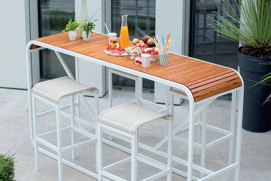 Example of a mid-sized island style slate floor and gray floor enclosed dining room design in Los Angeles with white walls and no fireplace