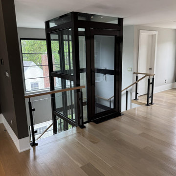 Project #136 | Modern Floating Staircase Encircling Glass Elevator