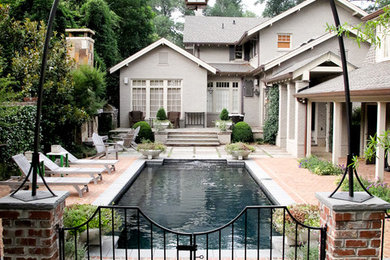 Pool - mid-sized traditional side yard brick and rectangular pool idea in Other