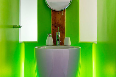 Photo of a modern bathroom in Montreal with a pedestal sink, green tile and green walls.