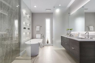 Design ideas for a large contemporary master bathroom in Vancouver with flat-panel cabinets, dark wood cabinets, a freestanding tub, an open shower, a one-piece toilet, multi-coloured tile, porcelain tile, grey walls, porcelain floors, an undermount sink, engineered quartz benchtops, beige floor and an open shower.