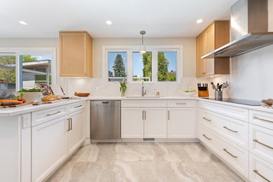 Example of a mid-sized transitional u-shaped porcelain tile and gray floor enclosed kitchen design in Ottawa with an undermount sink, recessed-panel cabinets, white cabinets, quartz countertops, white backsplash, quartz backsplash, stainless steel appliances, a peninsula and white countertops