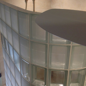 Glass block shower with a curved with frosted glass blocks