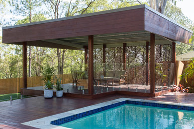 Inspiration for a mid-sized country backyard deck in Gold Coast - Tweed with a pergola.