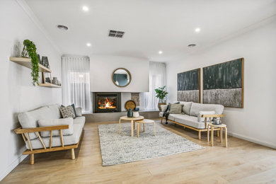 Inspiration for a large contemporary open concept living room in Melbourne with white walls, a standard fireplace and a metal fireplace surround.
