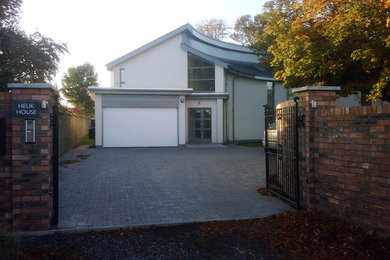 This is an example of a medium sized and beige contemporary two floor render house exterior in Edinburgh.