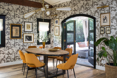 This is an example of a mid-sized transitional separate dining room in Los Angeles with multi-coloured walls, medium hardwood floors, no fireplace and brown floor.
