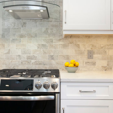 Porcelain Tile Backsplash Compliments the Sleek Glass Hood