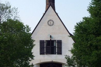 White two-story stucco exterior home photo in Cleveland with a shingle roof