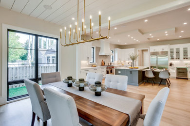 Example of a large transitional light wood floor, brown floor and shiplap ceiling dining room design in DC Metro