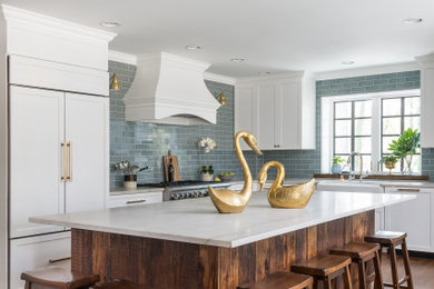 Large elegant u-shaped dark wood floor and brown floor eat-in kitchen photo in Atlanta with a farmhouse sink, shaker cabinets, white cabinets, quartzite countertops, blue backsplash, ceramic backsplash, stainless steel appliances, an island and white countertops