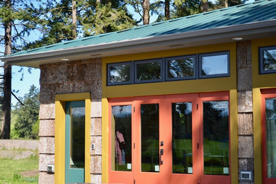 Small mountain style brown one-story wood house exterior photo in Seattle with a hip roof and a metal roof