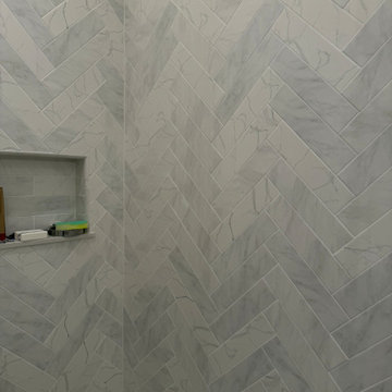 Custom Bathroom Renovation with Marble Herringbone Shower and Glass Enclosure