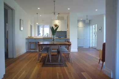 This is an example of a mid-sized transitional kitchen/dining combo in Sydney with white walls.