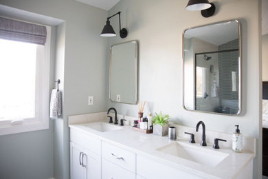 Inspiration for a large contemporary master blue tile and ceramic tile medium tone wood floor, brown floor and double-sink wet room remodel in Other with shaker cabinets, white cabinets, a one-piece toilet, gray walls, an undermount sink, quartz countertops, a hinged shower door, white countertops and a built-in vanity