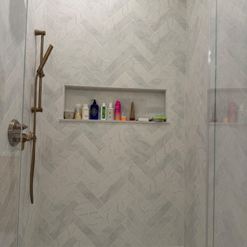 Custom Bathroom Renovation with Marble Herringbone Shower and Glass Enclosure