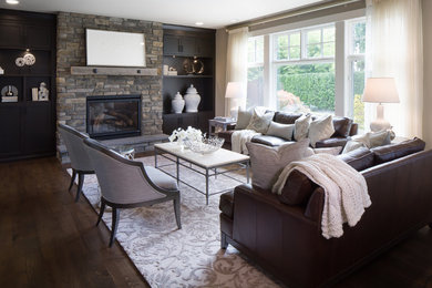 Living room - mid-sized transitional dark wood floor living room idea in Phoenix with beige walls, a standard fireplace, a stone fireplace and a media wall