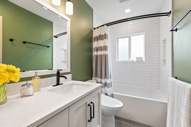 Small white tile and ceramic tile porcelain tile, gray floor and single-sink bathroom photo in Other with white cabinets, a bidet, green walls, an undermount sink, white countertops and a built-in vanity