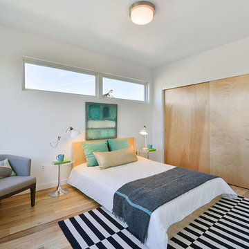 Bedroom full of natural wood, white walls and abundant light
