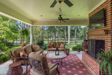 Large elegant backyard patio photo in New Orleans with a roof extension