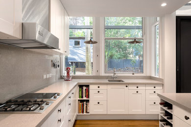 Enclosed kitchen - mid-sized contemporary l-shaped light wood floor and beige floor enclosed kitchen idea in Sydney with an undermount sink, shaker cabinets, white cabinets, gray backsplash, an island, concrete countertops, stone slab backsplash and stainless steel appliances