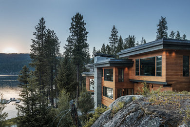Example of a huge minimalist split-level wood exterior home design in Boise with a metal roof