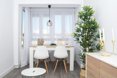 Design ideas for a small scandinavian dining room in Other with grey walls and grey floor.