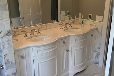 Bathroom - mid-sized traditional master gray tile marble floor bathroom idea in New York with an undermount sink, recessed-panel cabinets, white cabinets and gray walls
