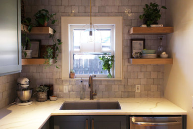 Example of a small transitional l-shaped medium tone wood floor eat-in kitchen design in Kansas City with shaker cabinets, green cabinets, quartz countertops, white backsplash, ceramic backsplash, stainless steel appliances, no island and white countertops