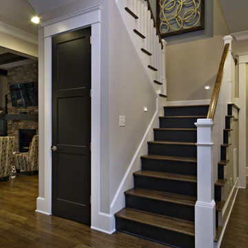 dark wood staircase with white wood railing