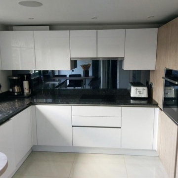 Handleless German Kitchen in Edgware with Glassplashback by Kudos Interior