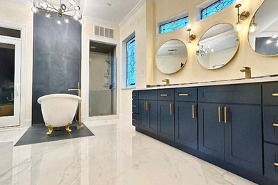 Master blue tile and porcelain tile porcelain tile and double-sink claw-foot bathtub photo in Dallas with shaker cabinets, blue cabinets, an undermount sink, quartz countertops and a built-in vanity