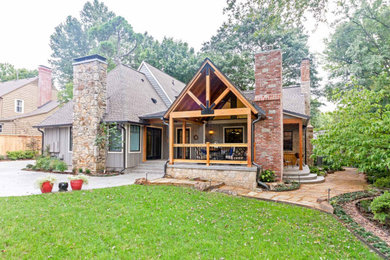 This is an example of a stamped concrete back porch design in Other with a fireplace and a roof extension.