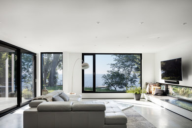 Living room - large contemporary open concept and formal concrete floor and gray floor living room idea with white walls, a concrete fireplace, a ribbon fireplace and a wall-mounted tv