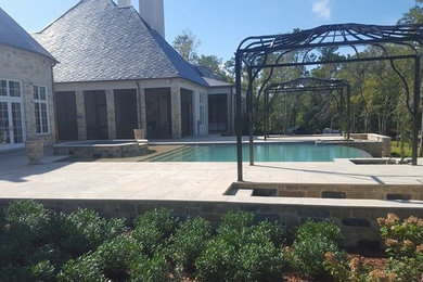 Large transitional backyard brick patio fountain photo in Miami with no cover
