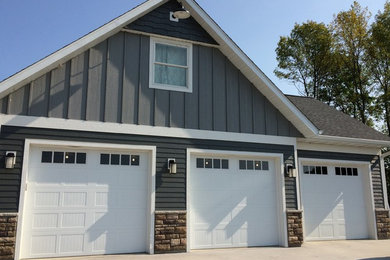 Inspiration for a mid-sized craftsman attached three-car garage workshop remodel in Minneapolis