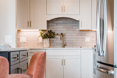 Kitchen - contemporary kitchen idea in Minneapolis with shaker cabinets, white cabinets, quartzite countertops, beige backsplash and a peninsula